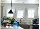 Bright kitchen with white shuttered windows and stainless steel faucet at 701 S Dobson Rd # 158, Mesa, AZ 85202