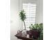 Window with closed white shutters accented with potted plants at 701 S Dobson Rd # 158, Mesa, AZ 85202