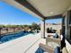 Covered patio with comfortable seating overlooking the pool at 11988 N 136Th Way, Scottsdale, AZ 85259