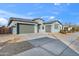 Single-story home with a two-car garage and desert landscaping at 14144 W Smoketree Dr, Surprise, AZ 85387