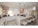 Modern kitchen with white cabinets, large island, and marble countertops at 25150 N Windy Walk Dr # 39, Scottsdale, AZ 85255