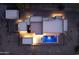 Aerial view of the modern home with a private pool illuminated at night, set in the desert landscape at 3703 S Avenida De Angeles --, Gold Canyon, AZ 85118