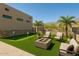 Backyard featuring a putting green, fire pit, lounge furniture, and desert views for outdoor enjoyment at 3703 S Avenida De Angeles --, Gold Canyon, AZ 85118