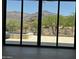 Stunning backyard view through sliding glass doors, featuring a pool, lush landscaping, and mountain views at 3703 S Avenida De Angeles --, Gold Canyon, AZ 85118