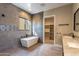 Stylish bathroom with modern tub, tiled shower, and a walk-in closet at 3703 S Avenida De Angeles --, Gold Canyon, AZ 85118