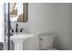 Well-lit bathroom featuring a modern pedestal sink, black fixtures, and a sleek, frameless mirror at 3703 S Avenida De Angeles --, Gold Canyon, AZ 85118