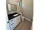 Powder bath featuring sleek black fixtures, white cabinetry, and modern rectangular mirror at 3703 S Avenida De Angeles --, Gold Canyon, AZ 85118