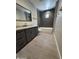 Modern bathroom featuring gray vanity, marble counters, framed mirror, and tiled shower/tub at 3703 S Avenida De Angeles --, Gold Canyon, AZ 85118