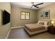 Comfortable bedroom with neutral tones, a mounted TV, and serene artwork, creating a calming and inviting atmosphere at 3703 S Avenida De Angeles --, Gold Canyon, AZ 85118