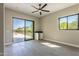 Bright bedroom with wood-look tile flooring, built-in desk, and pool views at 3703 S Avenida De Angeles --, Gold Canyon, AZ 85118
