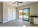 Bedroom features wood-look tile flooring, built-in desk, and sliding glass door to patio at 3703 S Avenida De Angeles --, Gold Canyon, AZ 85118
