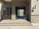 Inviting front entrance with stone accents and an open doorway showcasing the pool and mountain views at 3703 S Avenida De Angeles --, Gold Canyon, AZ 85118