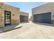 Spacious three-car garage with stone accents offers ample parking and complements the home's exterior at 3703 S Avenida De Angeles --, Gold Canyon, AZ 85118