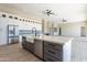 Open kitchen with a large island, farmhouse sink, stainless appliances and custom white cabinets at 3703 S Avenida De Angeles --, Gold Canyon, AZ 85118