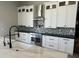 Kitchen with white cabinets, stainless steel appliances, and sleek black countertops at 3703 S Avenida De Angeles --, Gold Canyon, AZ 85118