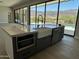 Kitchen island with a modern farmhouse sink, microwave and dishwasher overlooking the pool at 3703 S Avenida De Angeles --, Gold Canyon, AZ 85118