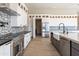 Bright kitchen with stainless steel appliances, farmhouse sink, and extensive white and grey cabinetry at 3703 S Avenida De Angeles --, Gold Canyon, AZ 85118