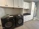 Spacious laundry room with dual Samsung washers/dryers and custom cabinetry for ample storage at 3703 S Avenida De Angeles --, Gold Canyon, AZ 85118