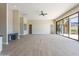Bright open-concept living room features light wood floors, neutral walls, and large sliding glass doors to outdoor space at 3703 S Avenida De Angeles --, Gold Canyon, AZ 85118
