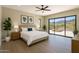 Serene main bedroom with hardwood floors, stylish decor, and a picturesque view from the adjacent patio, a perfect retreat at 3703 S Avenida De Angeles --, Gold Canyon, AZ 85118