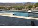 Inviting pool featuring stone accents, in-ground spa and scenic mountain views at 3703 S Avenida De Angeles --, Gold Canyon, AZ 85118
