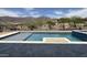 Inviting pool featuring stone accents, in-ground spa and scenic mountain views at 3703 S Avenida De Angeles --, Gold Canyon, AZ 85118