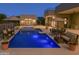 Stunning backyard pool area illuminated at dusk, featuring modern design, ambient lighting, and ample seating, great for relaxation at 3703 S Avenida De Angeles --, Gold Canyon, AZ 85118