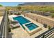 An aerial view of a luxurious pool and spa with outdoor kitchen and desert landscape at 3703 S Avenida De Angeles --, Gold Canyon, AZ 85118