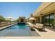 Stunning pool and patio area with seating, an umbrella and modern desert home design at 3703 S Avenida De Angeles --, Gold Canyon, AZ 85118