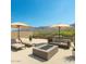 Relaxing rooftop patio setup with desert mountain views featuring comfortable lounge seating and a fire pit at 3703 S Avenida De Angeles --, Gold Canyon, AZ 85118