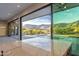 Open glass sliders reveal a pool and stunning mountain views in a modern backyard design at 3703 S Avenida De Angeles --, Gold Canyon, AZ 85118