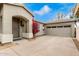 Tan house with a two-car garage and red flowers at 5185 S Eileen Dr, Chandler, AZ 85248