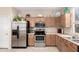Modern kitchen with stainless steel appliances and wood cabinets at 5185 S Eileen Dr, Chandler, AZ 85248