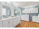 Bathroom featuring a double vanity, laundry area, and ample storage at 6819 E Grandview Dr, Scottsdale, AZ 85254