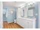 Bathroom boasting double sinks, ample cabinetry, and a separate toilet room at 6819 E Grandview Dr, Scottsdale, AZ 85254