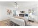 Bright bedroom featuring a ceiling fan, natural light, and stylish decor at 6819 E Grandview Dr, Scottsdale, AZ 85254
