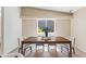 Dining room featuring a wooden table set with seating for six, bathed in natural light from the window at 6819 E Grandview Dr, Scottsdale, AZ 85254