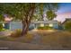 Charming single-story home featuring desert landscaping, mature tree, and welcoming walkway to the front door at 6819 E Grandview Dr, Scottsdale, AZ 85254