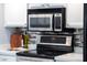 Kitchen with stainless steel microwave and oven range and backsplash at 6819 E Grandview Dr, Scottsdale, AZ 85254