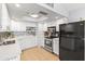 Well-lit kitchen with white cabinetry, stainless steel appliances, and tile flooring at 6819 E Grandview Dr, Scottsdale, AZ 85254