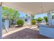 Cozy covered patio with brick flooring and well-maintained landscaping at 6819 E Grandview Dr, Scottsdale, AZ 85254