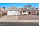 Single-story house with a two-car garage and desert landscaping at 8275 N 112Th Ave, Peoria, AZ 85345