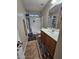 Clean bathroom with tub shower combo and wood vanity at 9 N 226Th Cir, Buckeye, AZ 85326