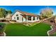 Spacious backyard with artificial turf and a covered patio at 9829 E Onza Ave, Mesa, AZ 85212