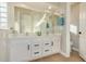 Double vanity bathroom with a large mirror and light-colored cabinets at 9829 E Onza Ave, Mesa, AZ 85212