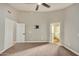 Well-lit bedroom with neutral carpeting and ceiling fan at 9829 E Onza Ave, Mesa, AZ 85212