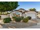 Single-story home with well-maintained landscaping and a two-car garage at 9829 E Onza Ave, Mesa, AZ 85212