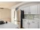 Stainless steel refrigerator in a modern kitchen with white cabinets at 9829 E Onza Ave, Mesa, AZ 85212