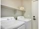 Laundry room with washer and dryer, plus overhead shelving at 9829 E Onza Ave, Mesa, AZ 85212