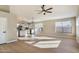 Bright living room features hardwood floors and an open concept design that flows into the kitchen at 9829 E Onza Ave, Mesa, AZ 85212